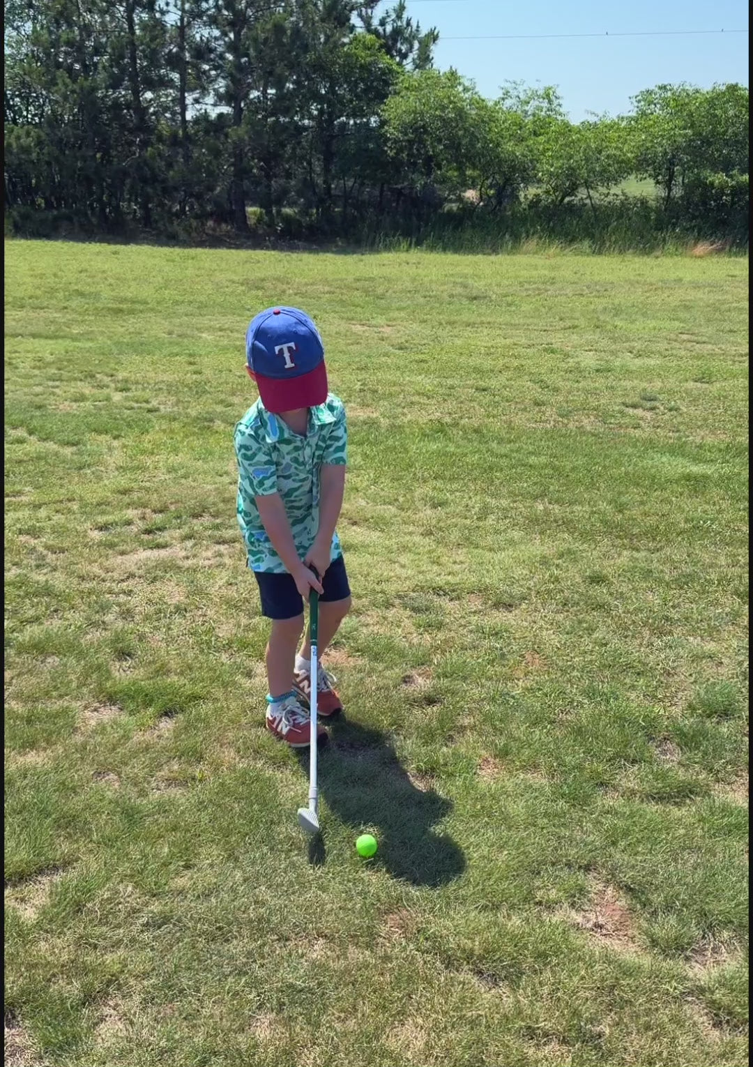 Load video: Toddler swinging a Tot Clubs Iron at a golf course